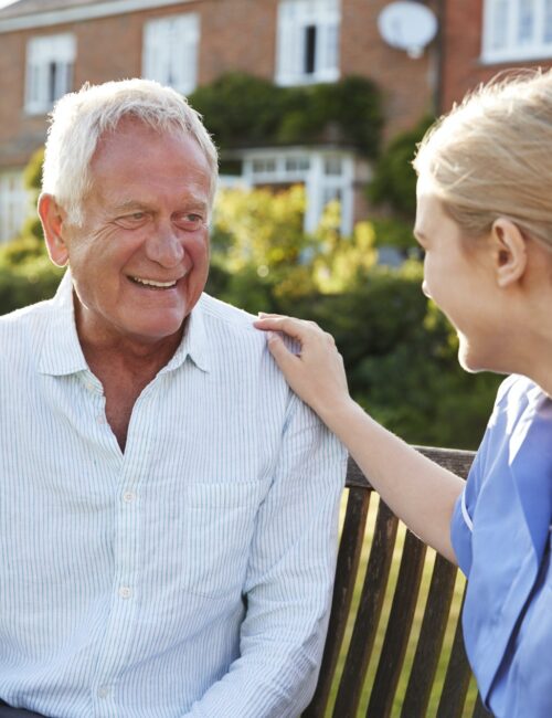 Nurse Talking To Senior Man In Residential Care Home